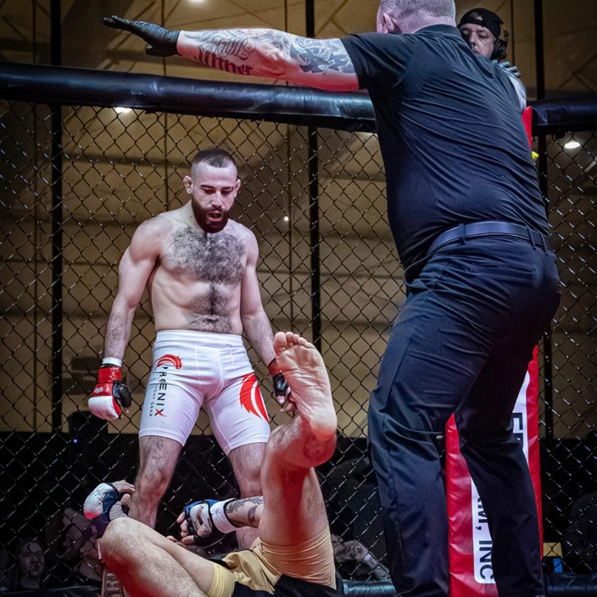 Michael Davtyan standing over his opponent after a win